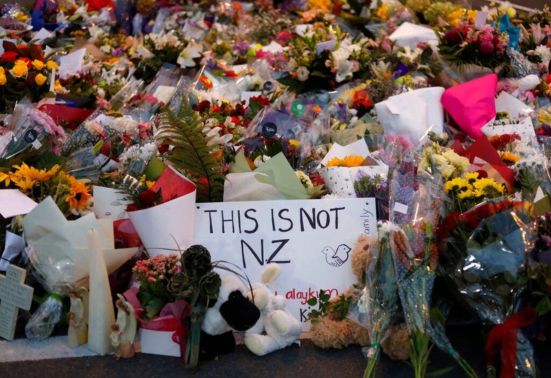 Mourners place flowers as they pay their respects at a makeshift memorial near the Masjid Al Noor mosque in Christchurch, New Zealand, Saturday, March 16, 2019