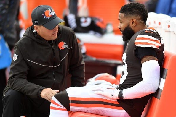Odell Beckham Jr is evaluated by a trainer on the Browns sideline