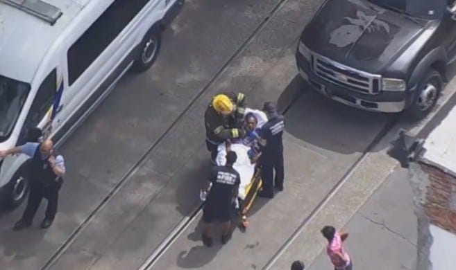A police officer receives medical attention after being injured in a crash while pursuing a stolen vehicle.