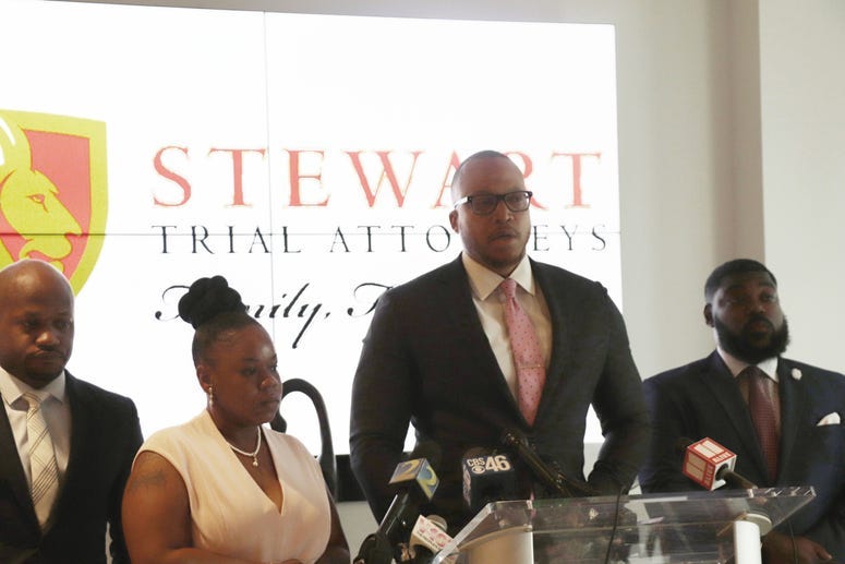 Atty. L. Chris Stewart (left), Tomika Miller (middle left), Atty Justin Miller (middle right), Stewart Trial Associate (right).