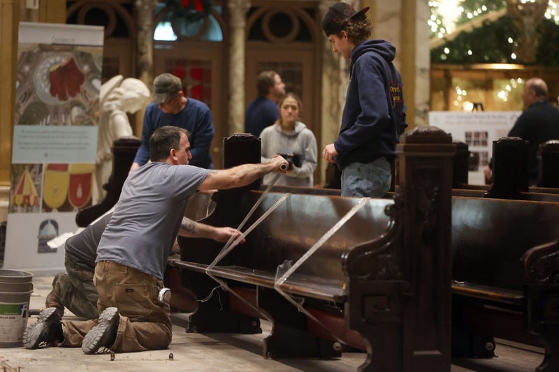 Crews restore pews and marble floors 