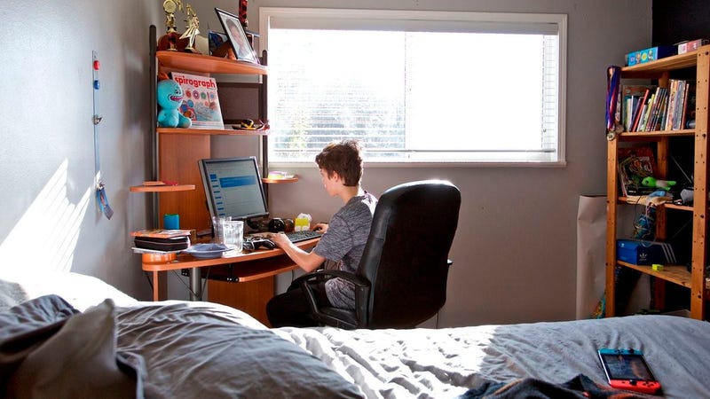 A student works on an online class assignment from his sixth grade class
