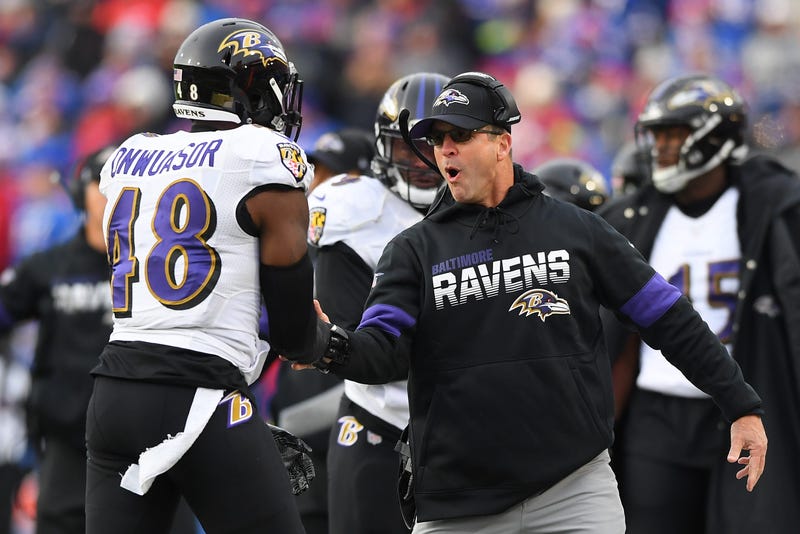 Ravens Head Coach John Harbaugh celebrates with Patrick Onwuasor after making a big tackle. 