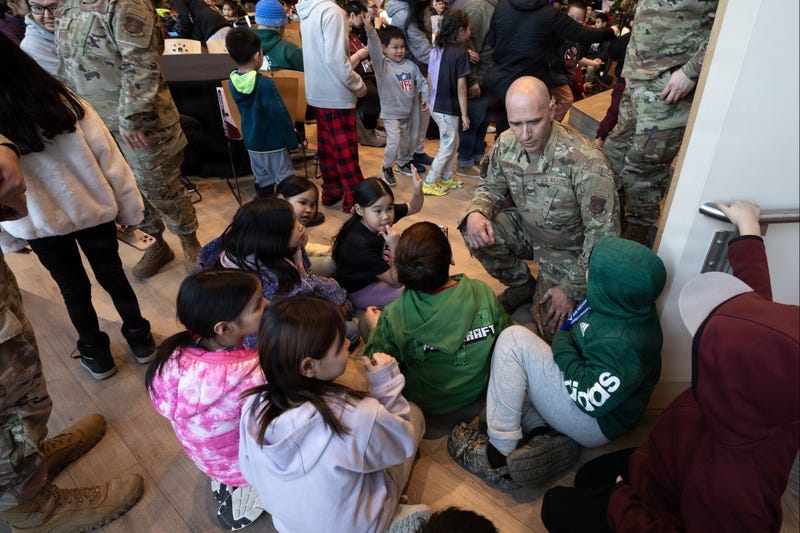 Alaska Air National Guard Tech. Sgt. Jonathan Goins, an aircraft metals technician assigned to the 176th Wing, interacts with children from Kipnuk and Kwigillingok during Operation Santa Claus 2025 at the Alaska Native Heritage Center in Anchorage, Alaska, on Dec. 14, 2025.