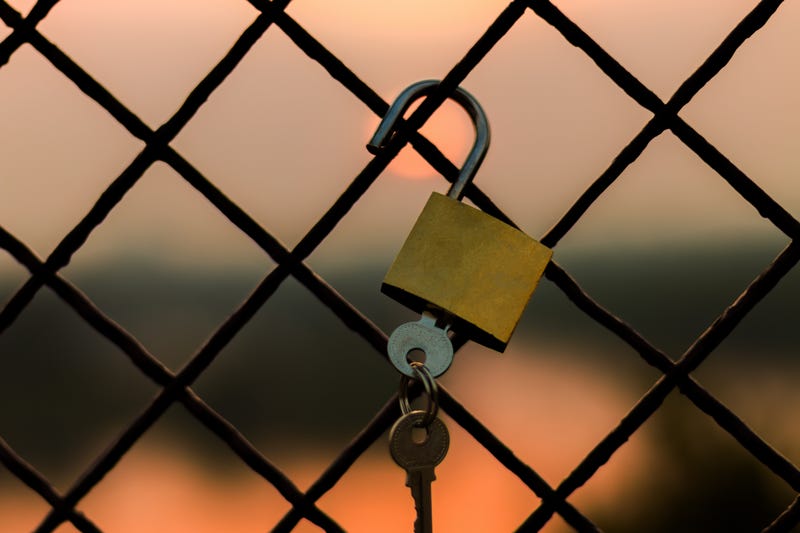 fence with unlocked padlock