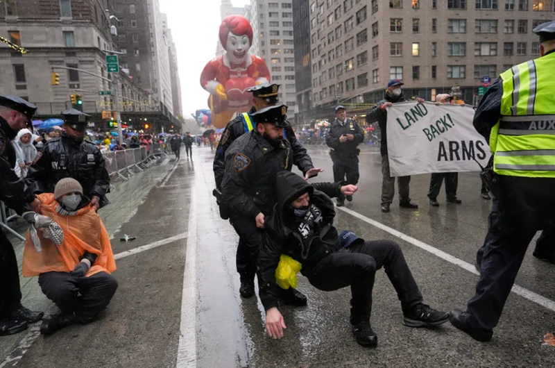 New York City police said they arrested 21 people after protesters sat down on the parade route with Palestinian flags and a "'Don't Celebrate Genocide'" banner.