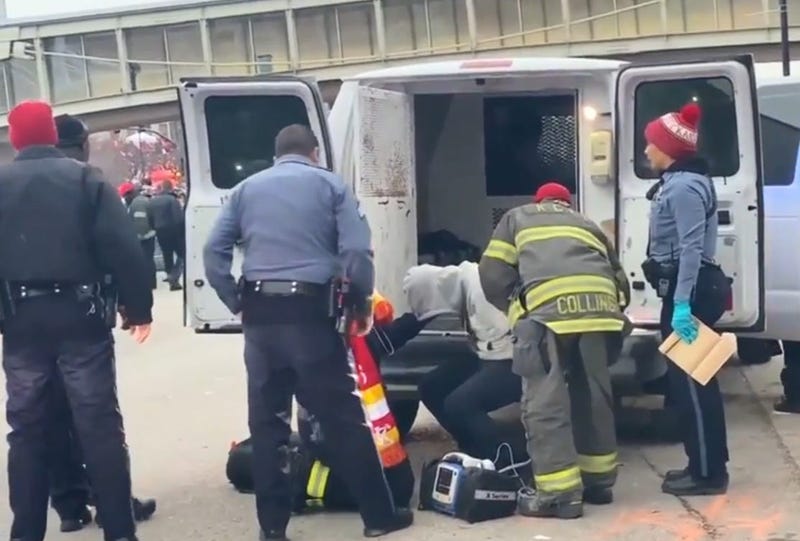 First responders treat a man who was arrested in connection with a police chase before the Kansas City Chiefs Super Bowl victory parade.