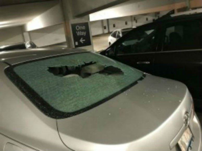 A vehicle with a broken rear windshield at a garage in the first block of East Adams Street, where 17 vehicles were damaged, Aug. 14, 2019.