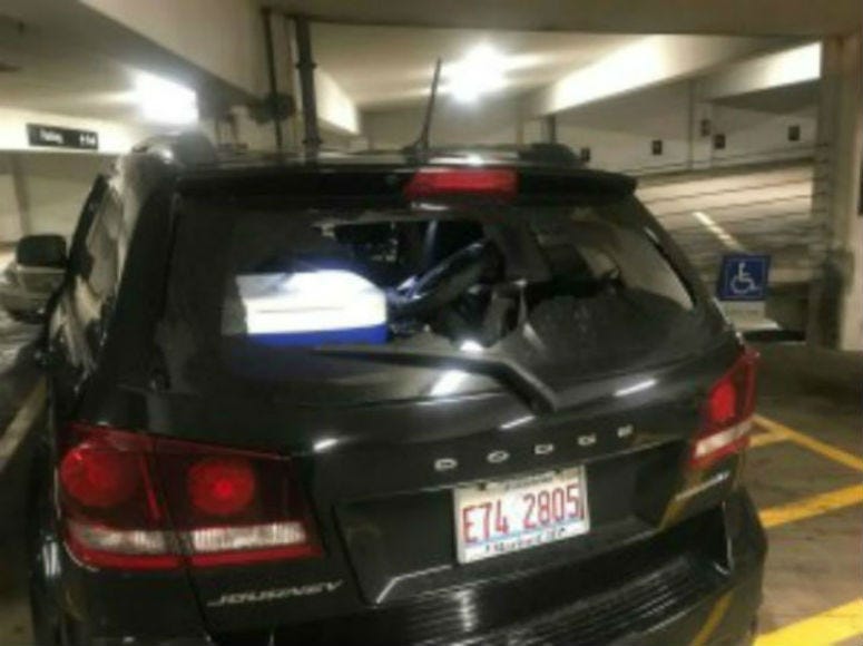 A vehicle with a broken rear windshield at a garage in the first block of East Adams Street, where 17 vehicles were damaged, Aug. 14, 2019.