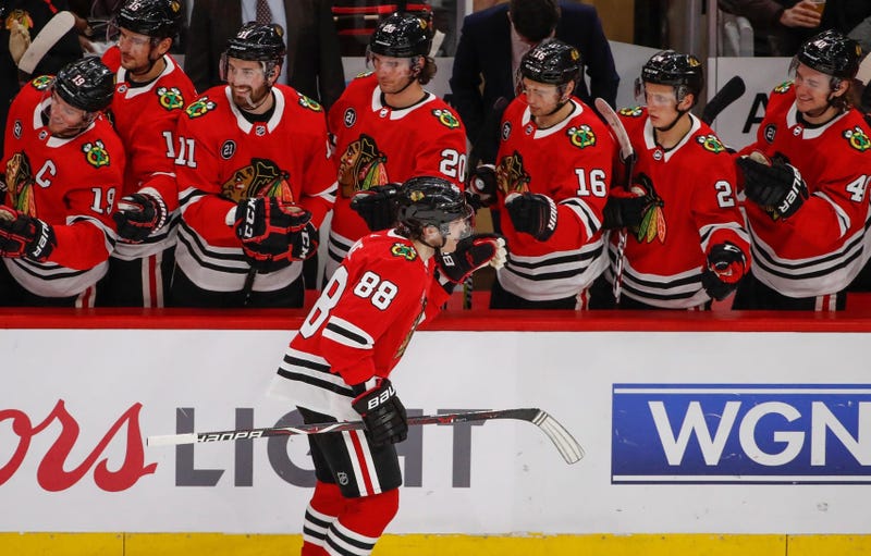 Blackhawks winger Patrick Kane (88) celebrates with teammates after scoring against the Blues.