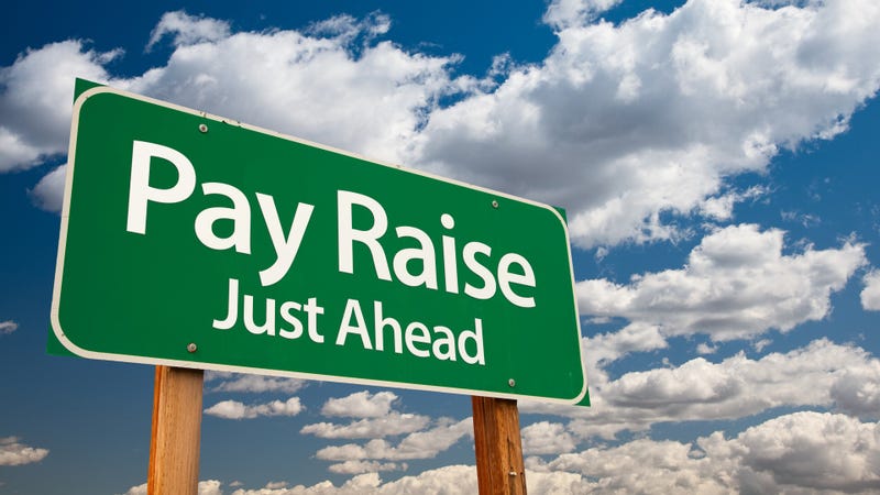 Pay raise green road sign - stock photo