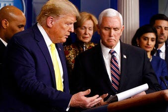 President Donald Trump gestures for Vice President Mike Pence to speak in the briefing room of the White House in Washington, Monday, March 9, 2020, about the coronavirus outbreak. (AP Photo/Patrick Semansky)