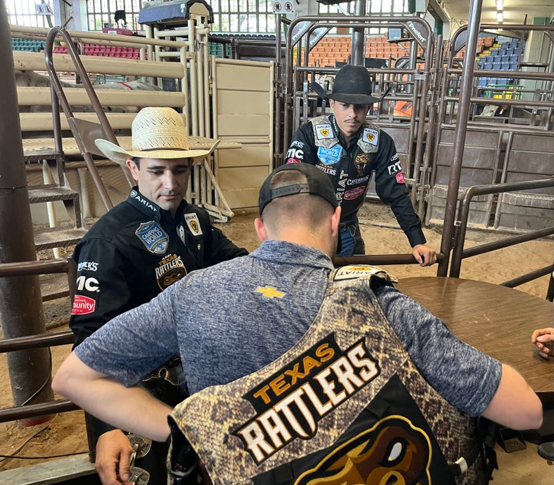 Racer and bull rider interacting