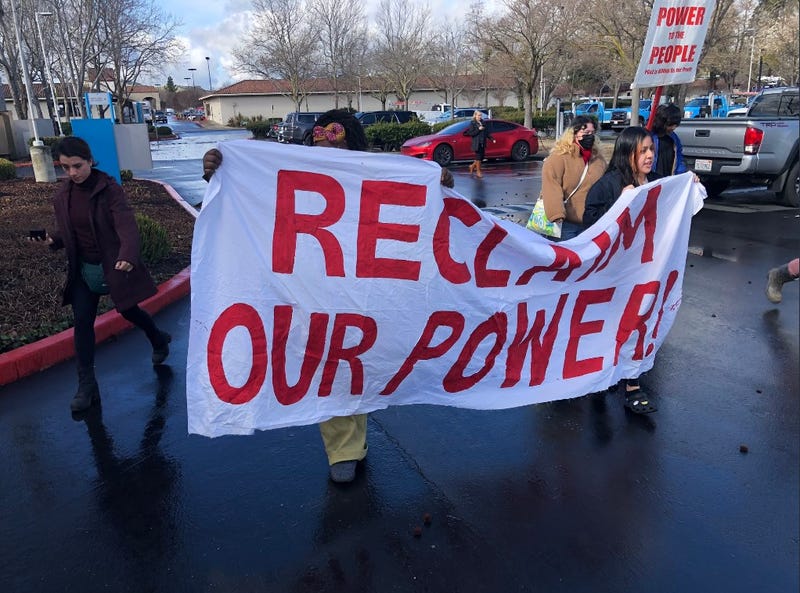 Protestors march onto PG&E property in San Ramon demanding that state regulators transform the utility into a public entity to better protect customers from rate hikes, power outages and wildfires.