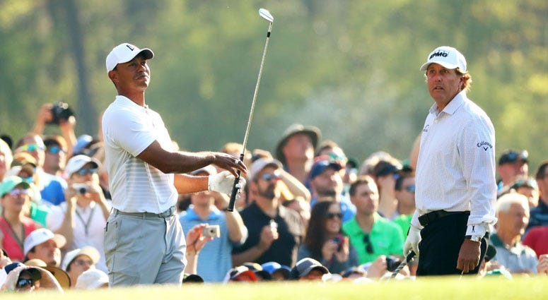 Phil Mickelson (left) shakes hands with Tiger Woods (right) after The Match: Tiger vs Phil golf match at Shadow Creek Golf Course in Las Vegas on Nov. 23, 2018. 