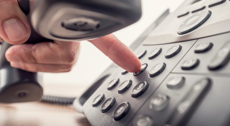 person dialing phone number