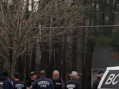 Henrico First Responders Discuss situation at Our Lady of Lourdes Church with Police lights at Moody Middle in distance. (Matt Demlein, WRVA)