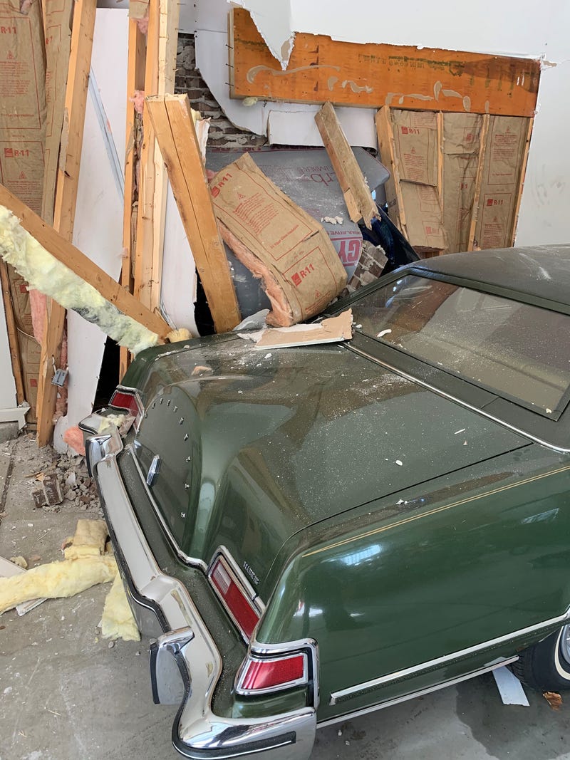 Classic car inside damaged garage