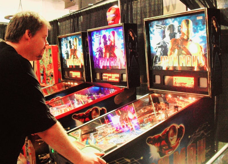 Man at pinball machine