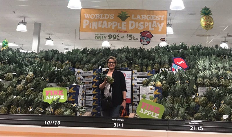 KMOX's Debbie Monterrey with pineapple display at Schnucks on Arsenal in St. Louis