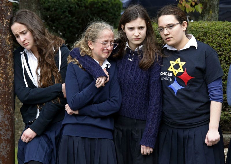 Students from the Yeshiva School in the Squirrel Hill neighborhood of Pittsburgh, pay their respects as the funeral procession for Dr. Jerry Rabinowitz passes their school en route to Homewood Cemetery.