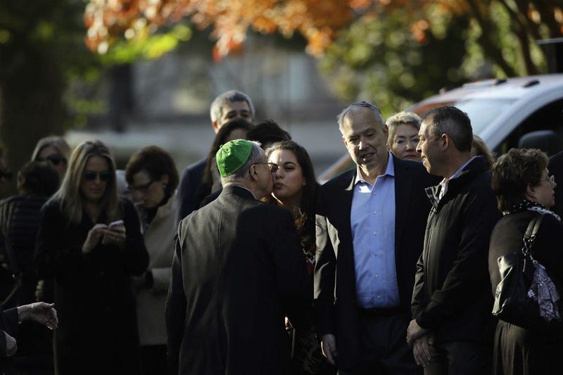 Mourners gather outside Rodef Shalom Congregation before the funeral services for brothers Cecil and David Rosenthal, Tuesday, Oct. 30, 2018, in Pittsburgh.