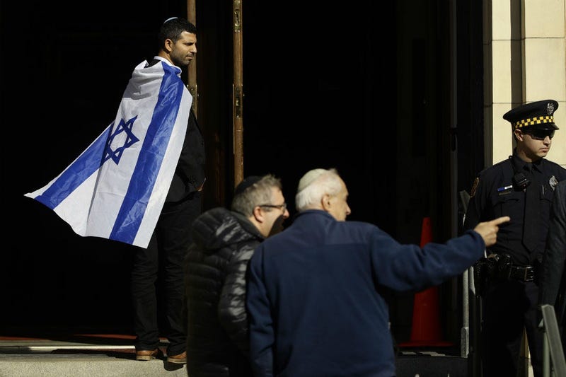 Mourners gather outside Rodef Shalom Congregation during the funeral services for brothers Cecil and David Rosenthal, Tuesday, Oct. 30, 2018, in Pittsburgh.