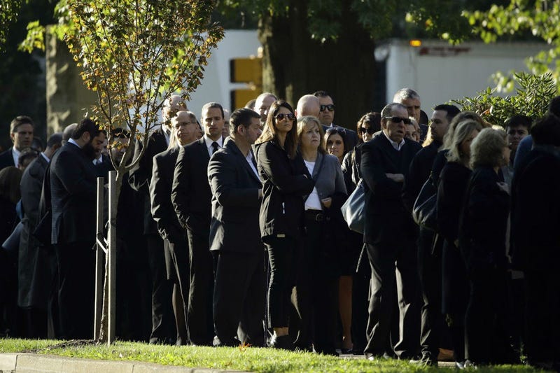 Mourners gather outside Rodef Shalom Congregation before the funeral services for brothers Cecil and David Rosenthal, Tuesday, Oct. 30, 2018, in Pittsburgh. 