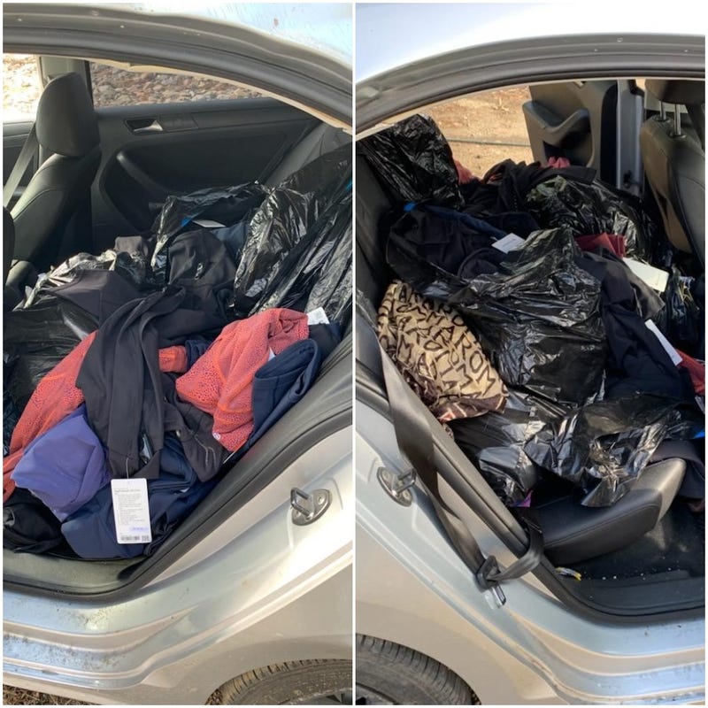 piles of clothes in car