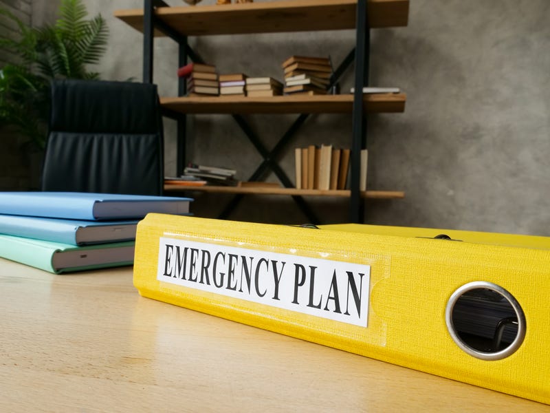 Emergency plan in the yellow folder on the desk