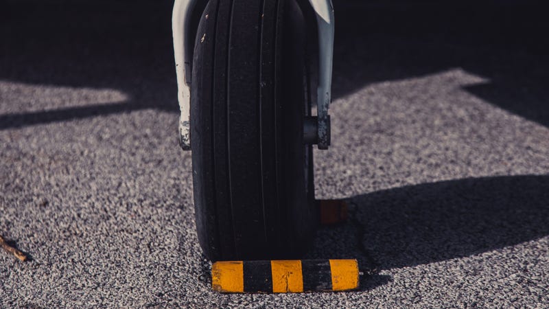 Landing wheels of a small airplane in an airport - stock photo