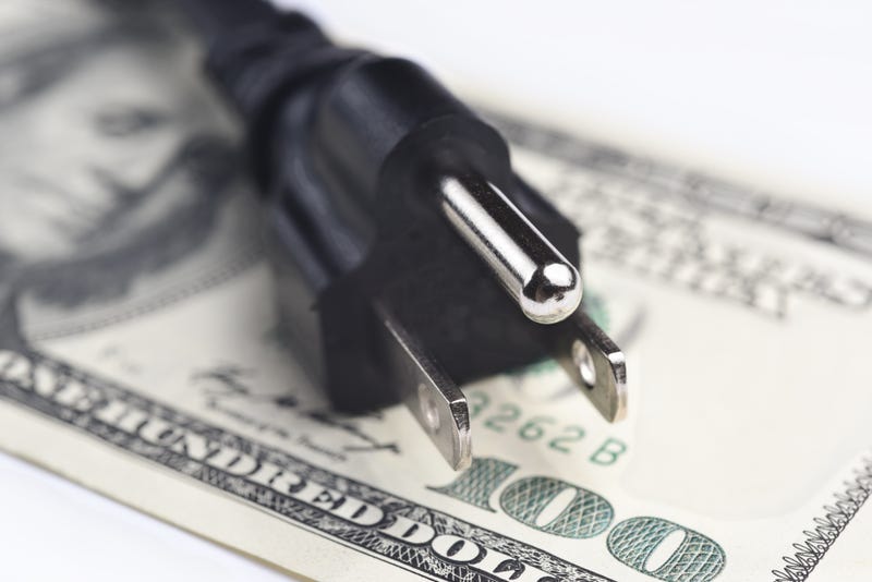 power cord over U.S. $100 bills