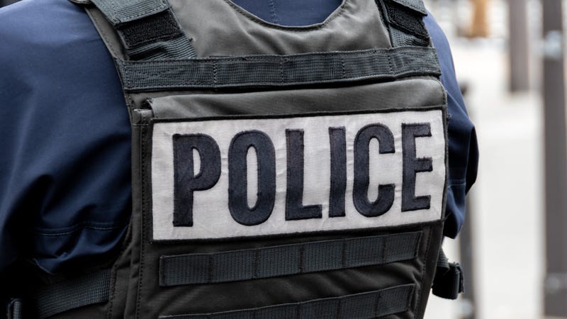 Close-up 'POLICE' marking written on the back of a bulletproof vest