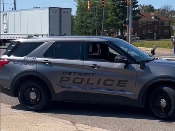 A Detroit Police traffic enforcement officer pulls out onto Gratiot Ave. to make a traffic stop.