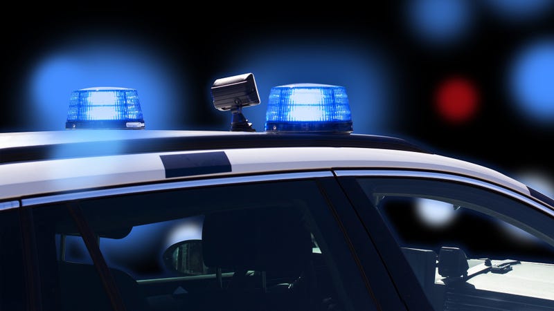 Police car at night with flashing lights on black background