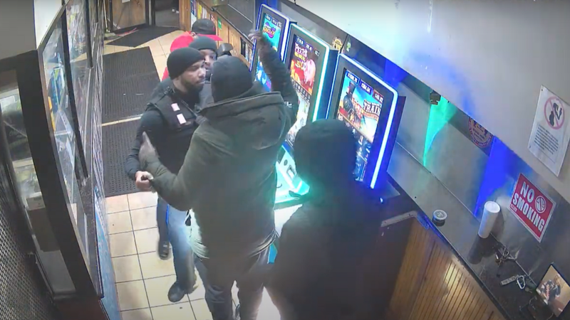 A still from surveillance video shows gambling machines in a stop-and-go corner store, where a police officer was shot and a man was killed.