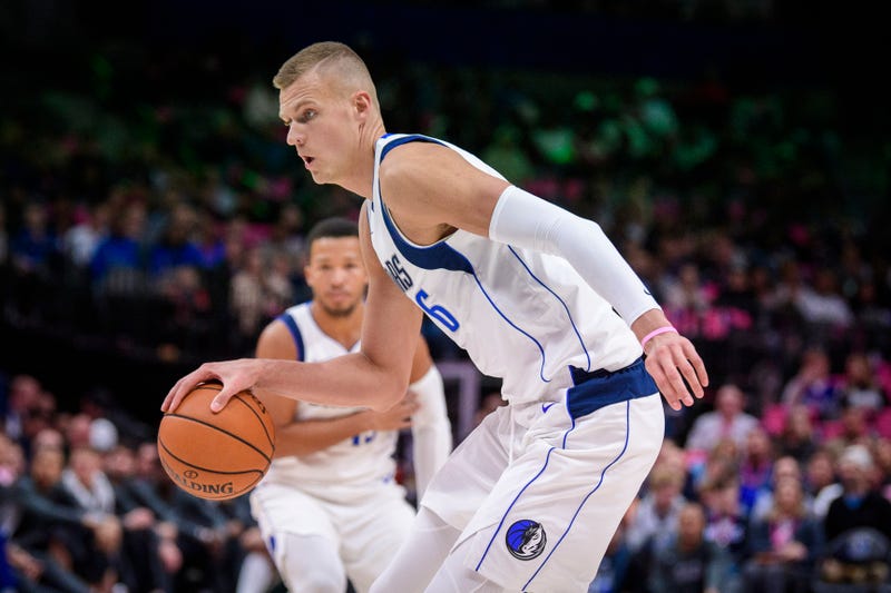 Kristaps Porzingis dribbles toward the basket during a Mavericks game. 