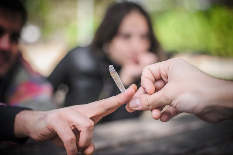 hands passing a joint