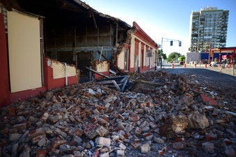 Debris from a collapsed wall of a building litters the ground after an earthquake struck Puerto Rico before dawn, in Ponce, Puerto Rico, Tuesday, Jan. 7, 2020. (AP Photo/Carlos Giusti)