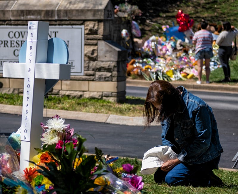 praying at memorial in Nashville