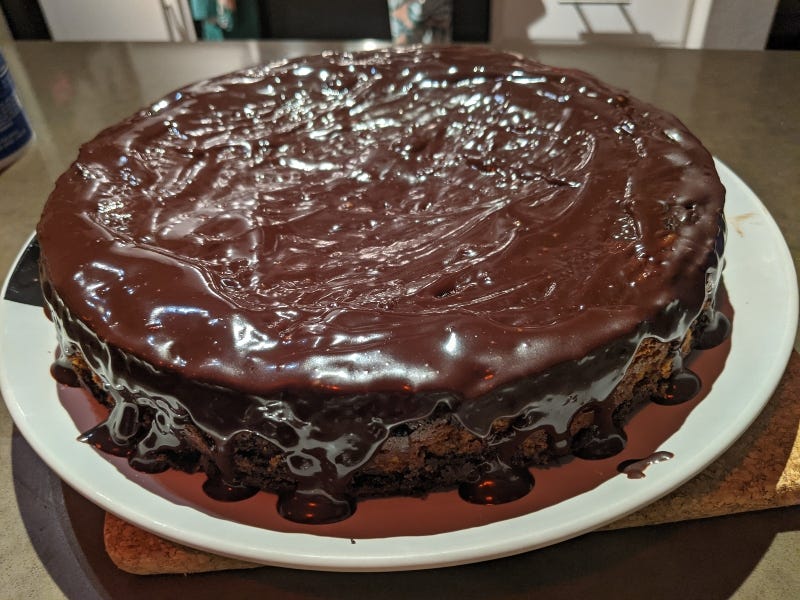 Melted chocolate over the Brownie Cheesecake Cake