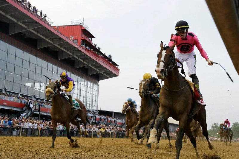War of Will, ridden by Tyler Gaffalione, right, crosses the finish line first to win the Preakness Stakes horse race at Pimlico Race Course.