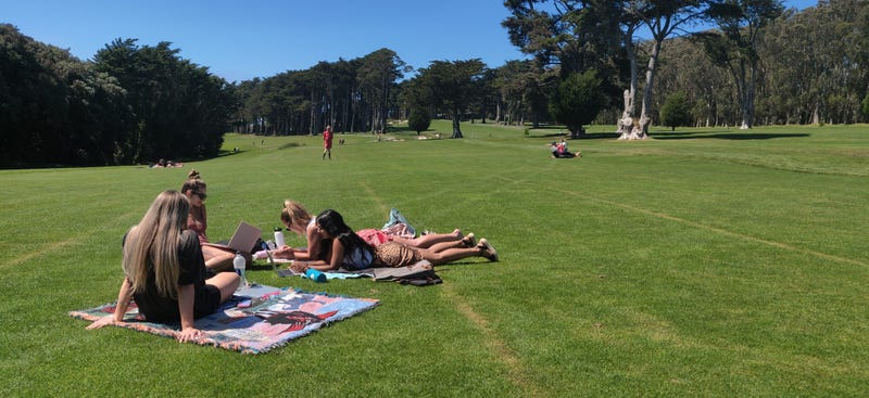 People relax at the Presidio Golf Course, which has closed to golfers and opened for hiking, walking and biking 