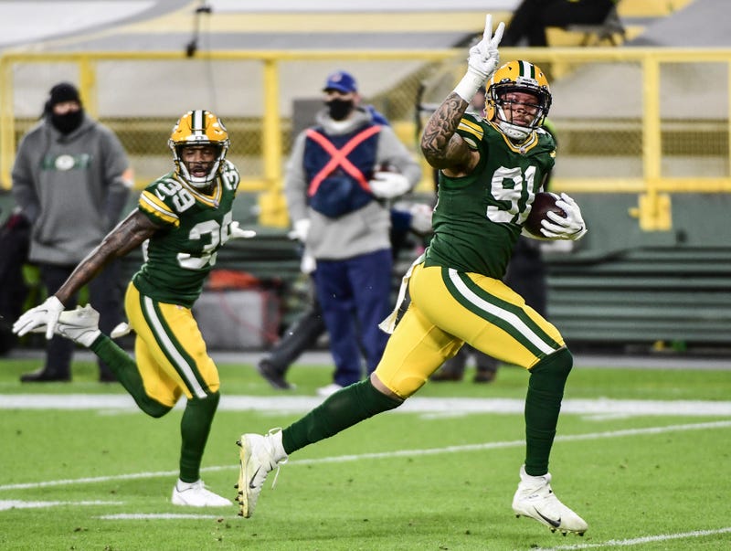 Nov 29, 2020; Green Bay, Wisconsin, USA; Green Bay Packers linebacker Preston Smith (91) returns a Chicago Bears fumble for a touchdown in the second quarter at Lambeau Field. Mandatory Credit: Benny Sieu-USA TODAY Sports