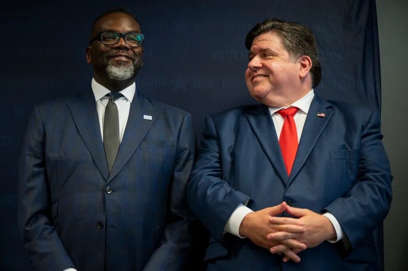 Gov. JB Pritzker smiles at Chicago Mayor Brandon Johnson
