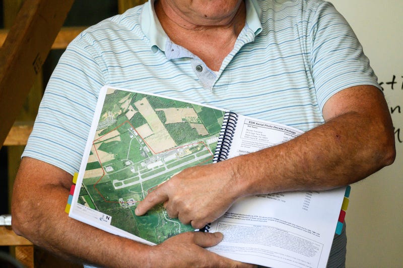 An attendee holds a map at a Benner Township neighborhood meeting about PFAS contamination in June 2022.