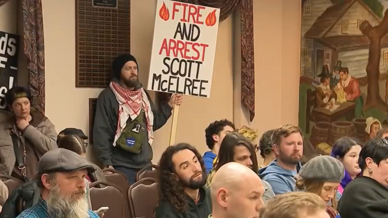 Person holds a sign that reads, "Fire and arrest Scott McElree" at a Quakertown Borough council meeting Wednesday night.