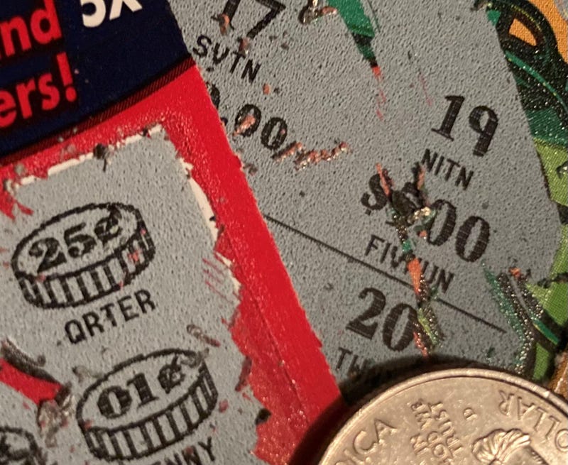 lottery tickets close up with quarter