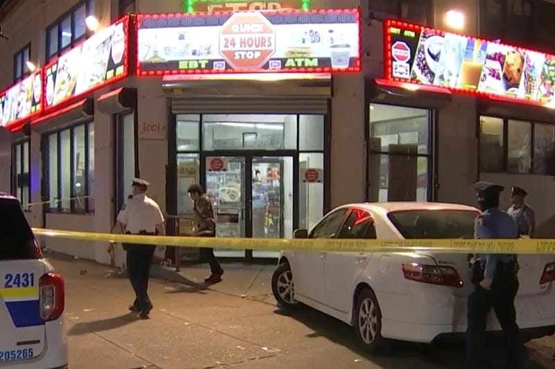 Police at the scene of an early Saturday shootout at a Kensington Quick Stop store.