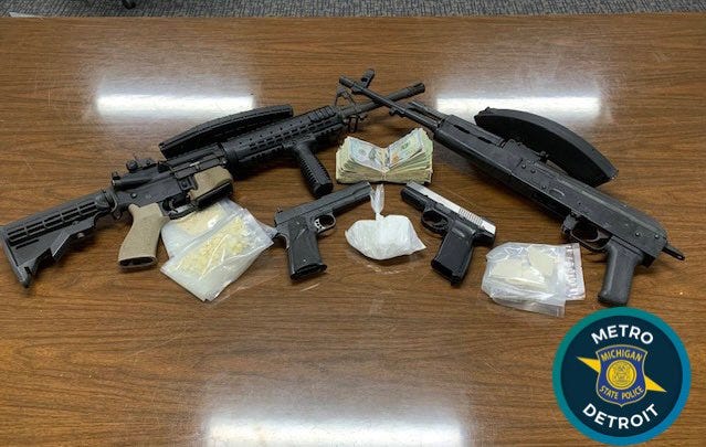 Michigan State Police display guns, drugs and money seized in task force raids in Detroit